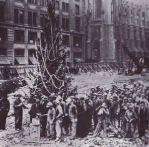The raising of the "first Christmas tree" by workers at the site of the future Rockefeller Center (New York City), under construction in 1931, establishing this annual tradition which continues more than 75 years later